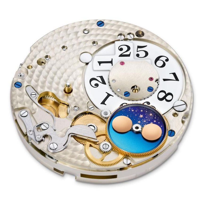Below the semicircular section on the dial, there is a rotating wheel, on which are usually mounted two round discs representing the Moon. Source: www.thejewelleryeditor.com